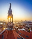 Budapest, Hungary - Old traditional metal tower and red rooftops of Castle District with rising sun, St. Stephens Basilica Royalty Free Stock Photo