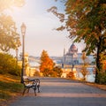 Budapest, Hungary - Romantic sunrise scene at Buda district with bench, lamp post, autumn foliage, Szechenyi Chain Bridge