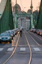 Sunset view of cars and cyclist on Liberty bridge at sunset in Budapest Hungary. Royalty Free Stock Photo