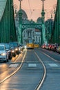 Cars and trams at sunset on Liberty Bridge in Budapest Hungary. Royalty Free Stock Photo