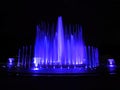 Blue color musical fountain. Magnificent night show of colorful lights, laser beams,