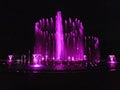 Purple color musical fountain. Magnificent night show of colorful lights, laser beams, Royalty Free Stock Photo