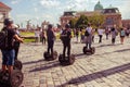 Tourist rides a electric scooter on old square sightseeing europe Royalty Free Stock Photo