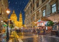 Budapest, Hungary - Snowy night at a Christmas market and shopping street with street-lamp, festive decoration