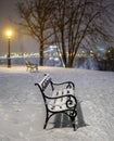 Budapest, Hungary - Two benches and lamp post in a snowy park at Buda district with Szechenyi Chain Bridge at background during he Royalty Free Stock Photo