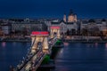 Budapest, Hungary - The world famous illuminated Szechenyi Chain Bridge Lanchid by night, lit up with national colours Royalty Free Stock Photo