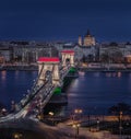 Budapest, Hungary - The world famous illuminated Szechenyi Chain Bridge Lanchid by night, lit up with national colors Royalty Free Stock Photo