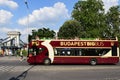 Budapest, red double decker sightseeing BigBus with tourists on deck. the Chainbridge in the background.