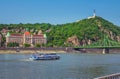 Budapest spring cityscape with Danube River, historic Gellert Hotel building and touristic boat Royalty Free Stock Photo