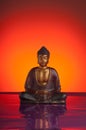 budda with red reflecting background