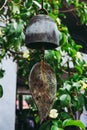 Buddha bell in the garden under the tree. in dark tone.