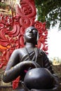 Buddha black statue with Red Caduceus