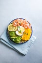 Buddha bowl with avocado, prawns, rice, on light background. Healthy food, clean eating, Buddha bowl, top view