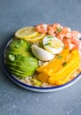 Buddha bowl with avocado, prawns, rice, on light background. Healthy food, clean eating, Buddha bowl, top view Royalty Free Stock Photo