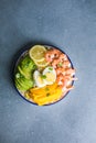 Buddha bowl with avocado, prawns, rice, on light background. Healthy food, clean eating, Buddha bowl, top view