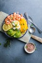 Buddha bowl with avocado, prawns, rice, on light background. Healthy food, clean eating, Buddha bowl, top view Royalty Free Stock Photo