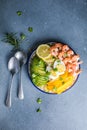 Buddha bowl with avocado, prawns, rice, on light background. Healthy food, clean eating, Buddha bowl, top view