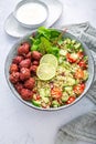 Buddha bowl with beetroot falafel balls and lemon yogurt dip. Tabbouleh salad.