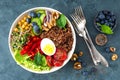 Buddha bowl dinner with boiled egg, chickpea, fresh tomato, sweet pepper, cucumber, savoy cabbage, red onion, green sprouts Royalty Free Stock Photo