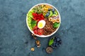 Buddha bowl dinner with boiled egg, chickpea, fresh tomato, sweet pepper, cucumber, savoy cabbage, red onion, green sprouts Royalty Free Stock Photo