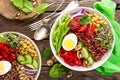 Buddha bowl dish with boiled egg, chickpea, fresh tomato, sweet pepper, cucumber, savoy cabbage, red onion, green sprouts, spinach Royalty Free Stock Photo