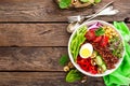 Buddha bowl dish with boiled egg, chickpea, fresh tomato, sweet pepper, cucumber, savoy cabbage, red onion, green sprouts, spinach Royalty Free Stock Photo