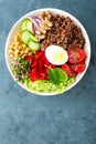 Buddha bowl dish with boiled egg, chickpea, fresh tomato, sweet pepper, cucumber, savoy cabbage, red onion, green sprouts, spinach Royalty Free Stock Photo