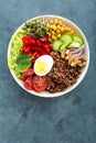 Buddha bowl dish with boiled egg, chickpea, fresh tomato, sweet pepper, cucumber, savoy cabbage, red onion, green sprouts, spinach Royalty Free Stock Photo