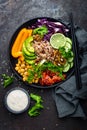Buddha bowl dish with brown rice, avocado, pepper, tomato, cucumber, red cabbage, chickpea, fresh lettuce salad and walnuts. Healt Royalty Free Stock Photo