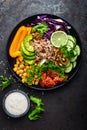 Buddha bowl dish with brown rice, avocado, pepper, tomato, cucumber, red cabbage, chickpea, fresh lettuce salad and walnuts. Healt Royalty Free Stock Photo