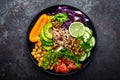 Buddha bowl dish with brown rice, avocado, pepper, tomato, cucumber, red cabbage, chickpea, fresh lettuce salad and walnuts. Healt Royalty Free Stock Photo