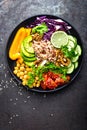 Buddha bowl dish with brown rice, avocado, pepper, tomato, cucumber, red cabbage, chickpea, fresh lettuce salad and walnuts. Healt Royalty Free Stock Photo