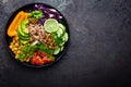 Buddha bowl dish with brown rice, avocado, pepper, tomato, cucumber, red cabbage, chickpea, fresh lettuce salad and walnuts. Healt Royalty Free Stock Photo