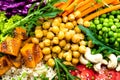 Bowl dish with brown rice, cucumber, tomato, green peas, red cabbage, chickpea, fresh lettuce salad and cashew nuts. Healthy balan Royalty Free Stock Photo