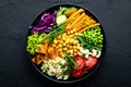 Bowl dish with brown rice, cucumber, tomato, green peas, red cabbage, chickpea, fresh lettuce salad and cashew nuts. Healthy balan Royalty Free Stock Photo