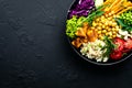 Bowl dish with brown rice, cucumber, tomato, green peas, red cabbage, chickpea, fresh lettuce salad and cashew nuts. Healthy balan Royalty Free Stock Photo