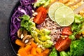 Buddha bowl dish with chicken fillet, brown rice, avocado, pepper, tomato, broccoli, red cabbage, chickpea, fresh lettuce salad, p Royalty Free Stock Photo