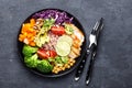 Buddha bowl dish with chicken fillet, brown rice, avocado, pepper, tomato, broccoli, red cabbage, chickpea, fresh lettuce salad, p Royalty Free Stock Photo