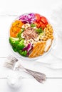 Buddha bowl dish with chicken fillet, brown rice, pepper, tomato, broccoli, onion, chickpea, fresh lettuce salad, cashew and walnu Royalty Free Stock Photo