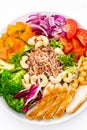 Buddha bowl dish with chicken fillet, brown rice, pepper, tomato, broccoli, onion, chickpea, fresh lettuce salad, cashew and walnu Royalty Free Stock Photo