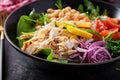 Buddha bowl dish with chicken fillet, chickpeas, tomatoes, red onion, fresh green salad and seed sesame. Royalty Free Stock Photo