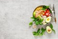 Buddha bowl with grilled chicken breast, tomato, onion, corn, avocado, fresh basil salad and rice, healthy balanced eating Royalty Free Stock Photo
