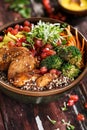 Buddha Bowl with Grilled Chicken, Broccoli, Quinoa, Carrots, Avocado and Turmeric sauce Royalty Free Stock Photo