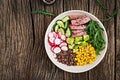 Buddha bowl lunch with grilled beef steak and quinoa, corn, avocado, cucumber Royalty Free Stock Photo