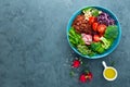 Buddha bowl meal with kale, spinach and chard leaves, brown rice, tomato, broccoli, radish, fresh green sprouts and pine nuts. Hea