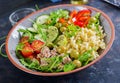 Buddha bowl. Pasta salad with tuna, tomatoes, olives, cucumber, sweet pepper