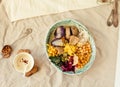 Detox lunch with a purple potato, stewed spinach, and hummus with corn crackers