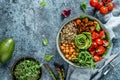 Buddha bowl salad with baked sweet potatoes, chickpeas, quinoa, tomatoes, arugula, avocado, sprouts on light blue background Royalty Free Stock Photo