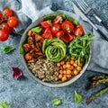 Buddha bowl salad with baked sweet potatoes, chickpeas, quinoa, tomatoes, arugula, avocado, sprouts on light blue background with Royalty Free Stock Photo