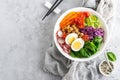 Buddha bowl salad with chickpeas, sweet pepper, tomato, cucumber, red cabbage kale, fresh radish, spinach leaves and boiled egg Royalty Free Stock Photo